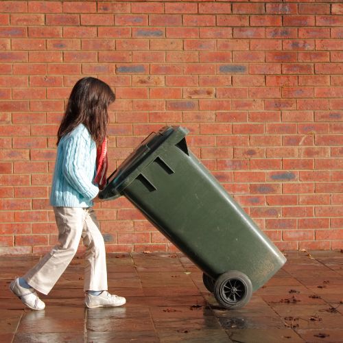 Girl taking out the trash bin